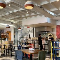 May be an image of 2 people, lighting, table, indoors and text that says 'አሉ4 SOLUNTO NTOBAKING BAKING CO. San Diego,'